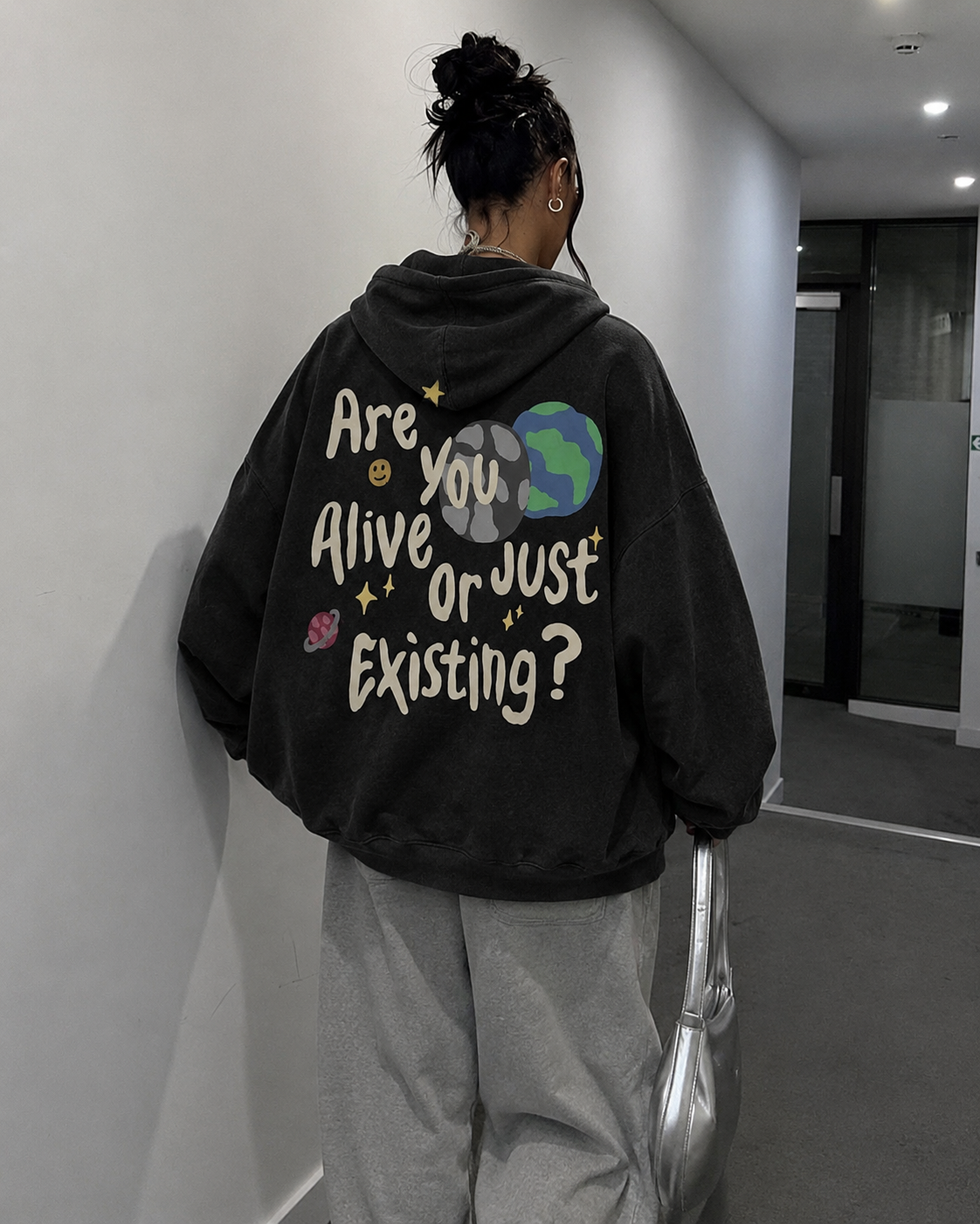 Black oversized Are You Alive hoodie indoor back view