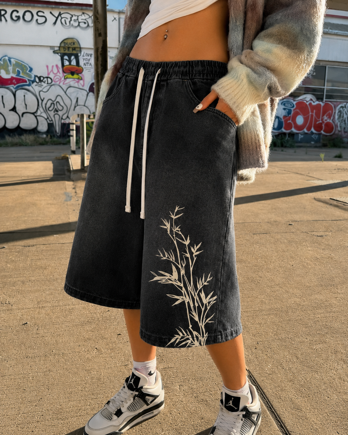 Close-up of bamboo embroidery on black jorts worn