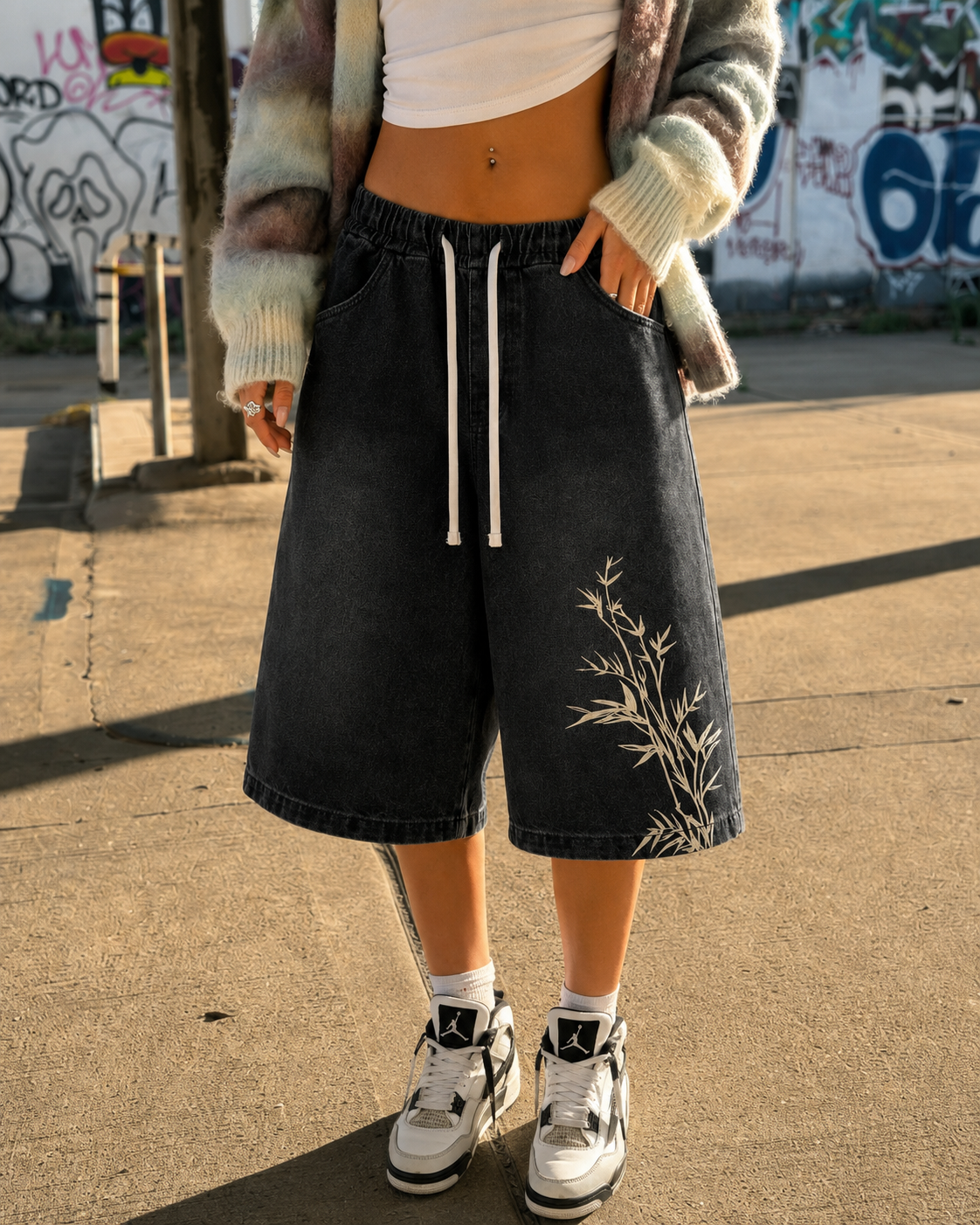 Detail of black bamboo jorts worn, bamboo motif on the right leg