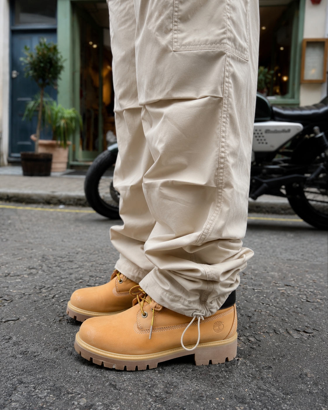Adjustable ankle detail on beige parachute pants
