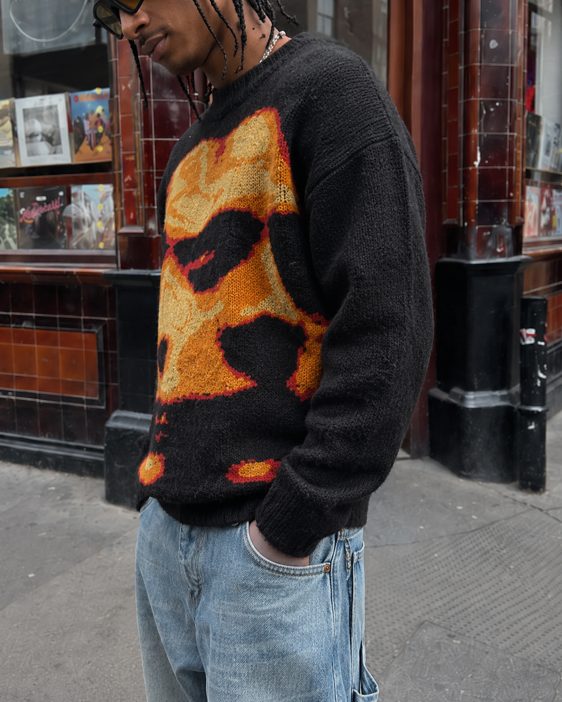 Black graphic sweater side view worn with textured knit