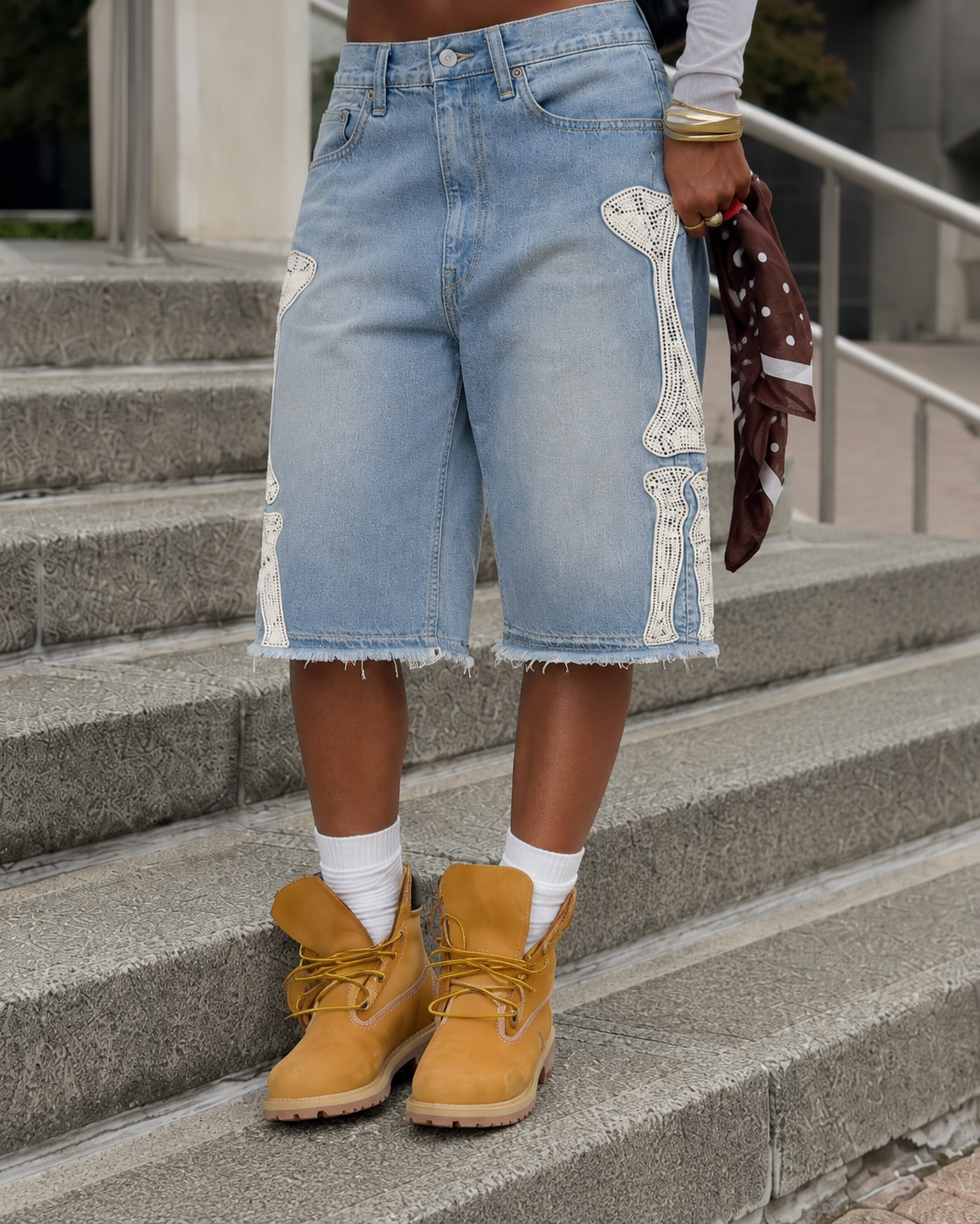 Low view of the blue Bone Jorts with frayed hem and boots