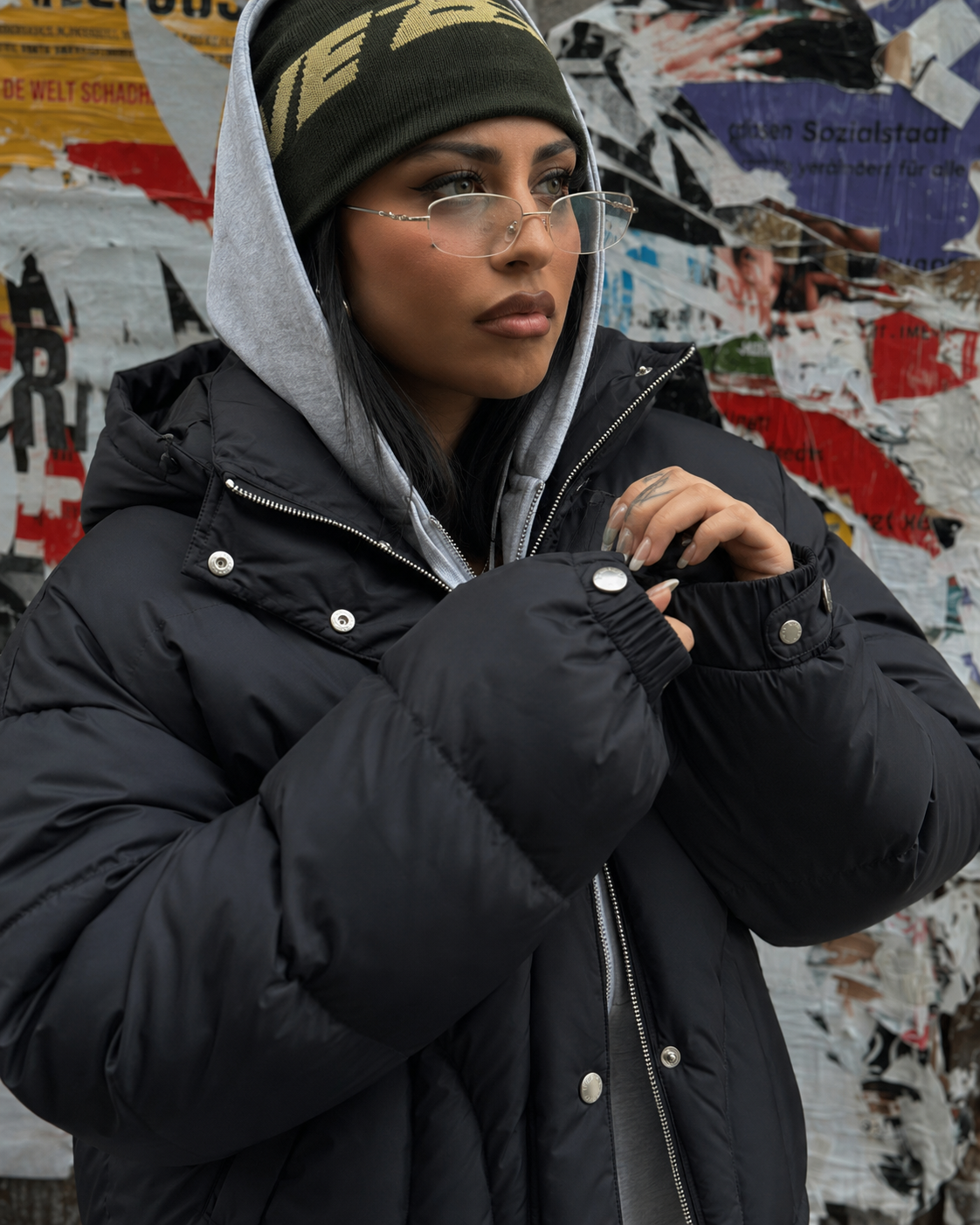 Black cropped puffer jacket zip cuff button texture detail