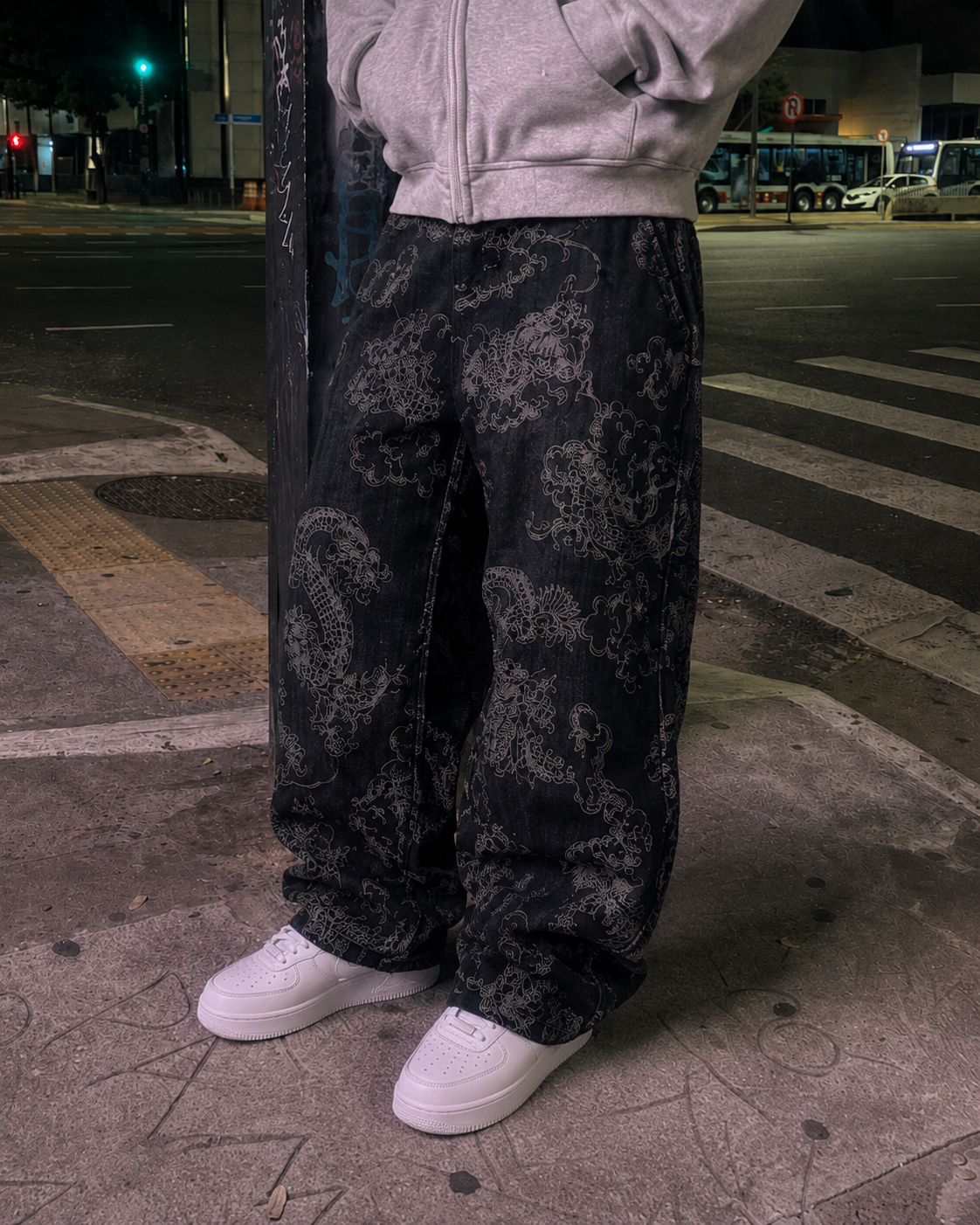 Black dragon pants leg print detail
