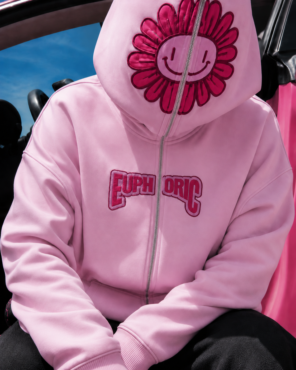 Pink full zip hoodie close-up of full-face hood with smiling flower