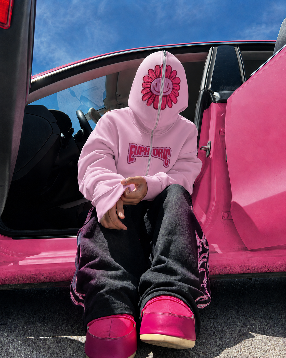 Pink Y2K full zip hoodie worn streetwear beside a pink car
