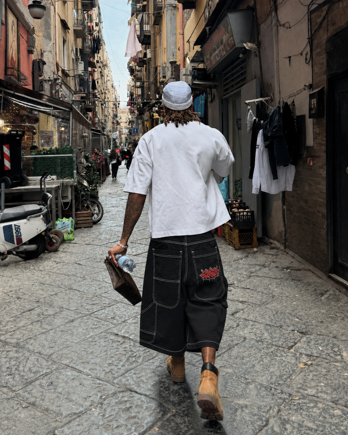 Graffiti Jorts worn from the back in a Naples alley with visible graffiti tag