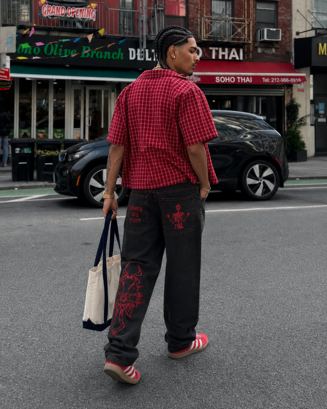 Black embroidered jeans with red stitching, back view