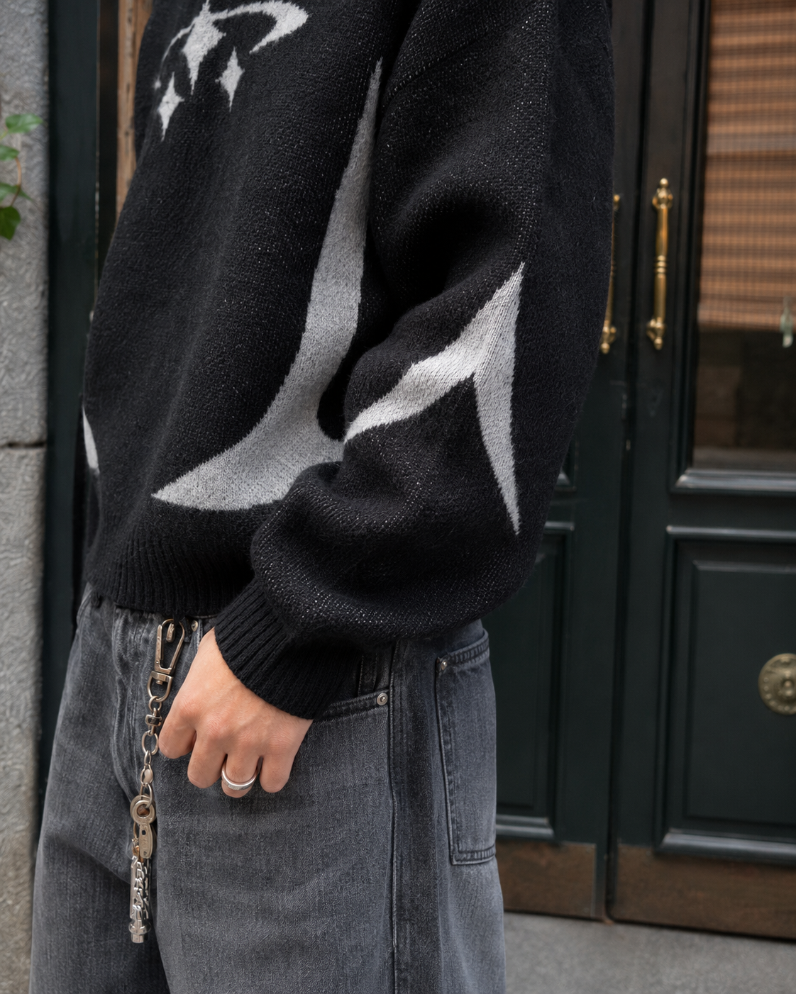 Black Y2K sweater sleeve and contrast motif detail