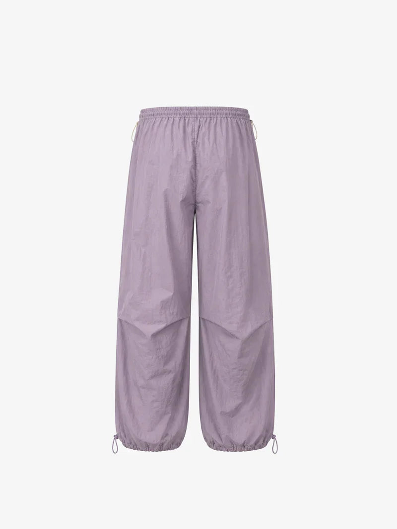 Purple parachute pants back view on white background