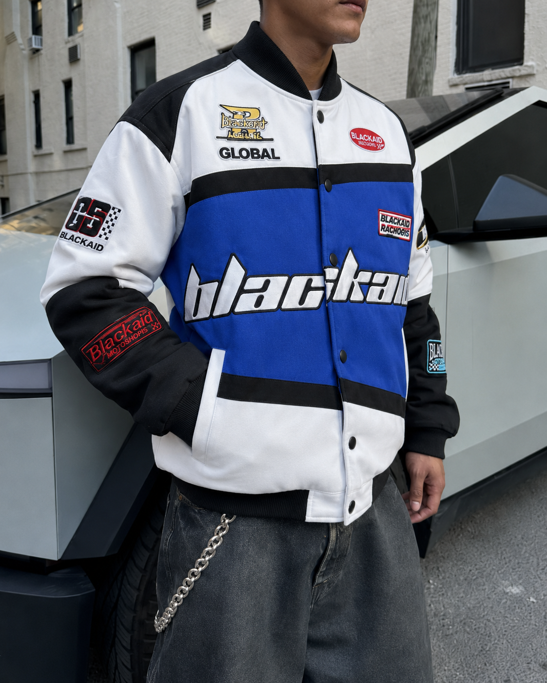 Blue racing jacket patch and button detail