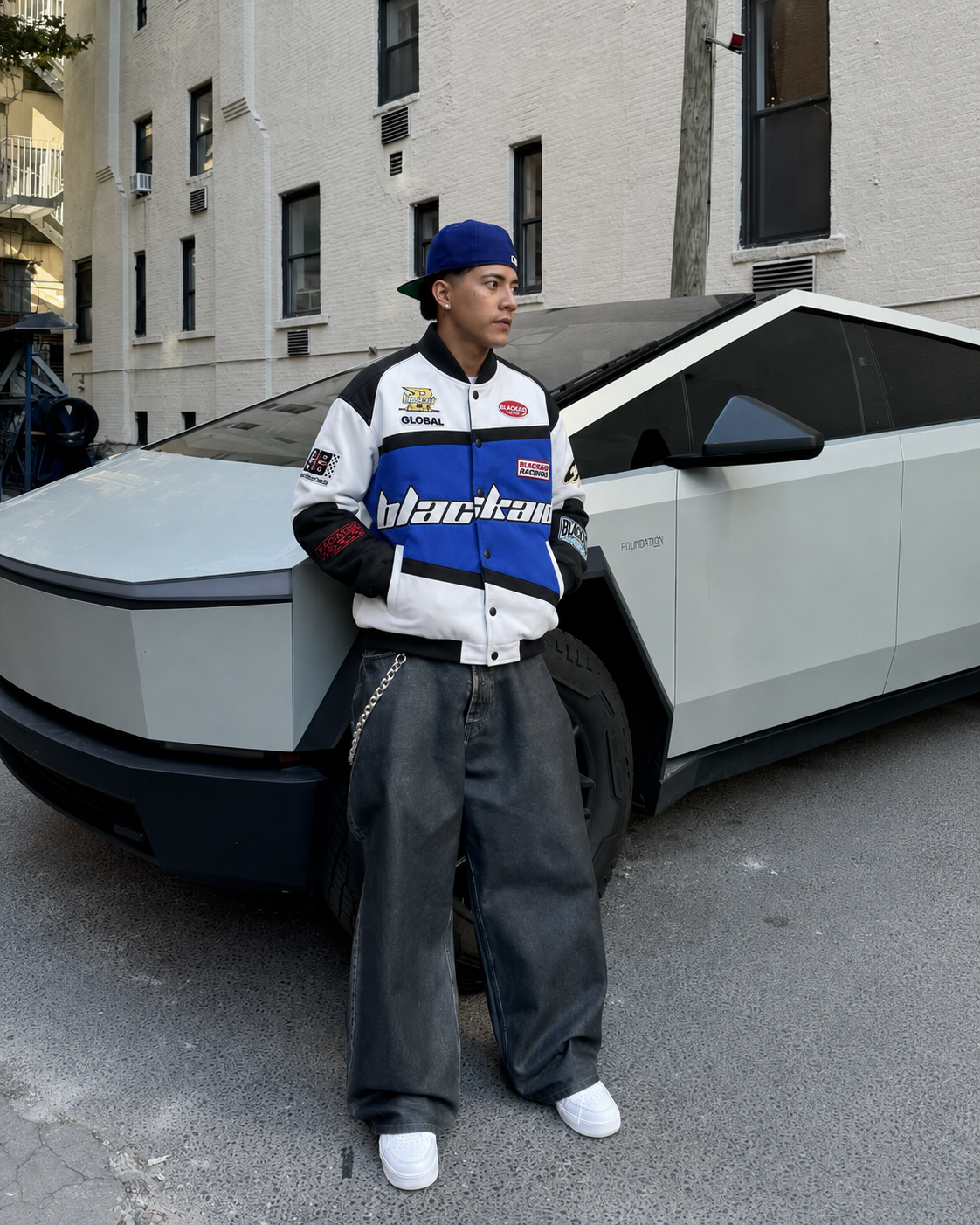 Blue racing jacket worn with baggy jeans