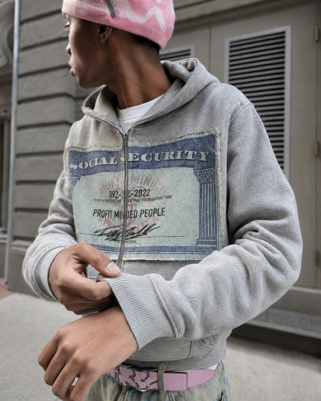 Graphic patch detail on gray zip up hoodie
