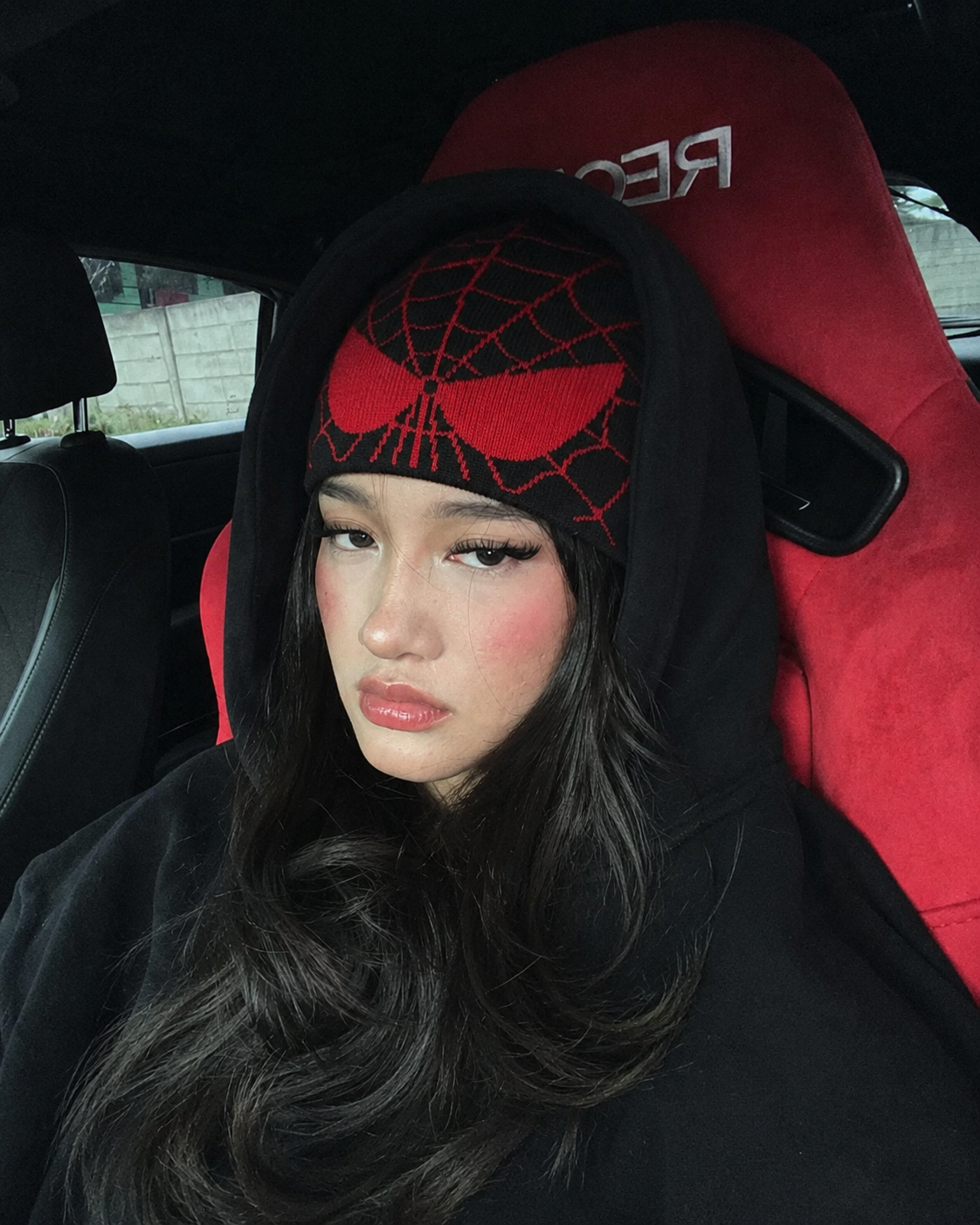 Black and red Spiderman beanie worn with hoodie streetwear