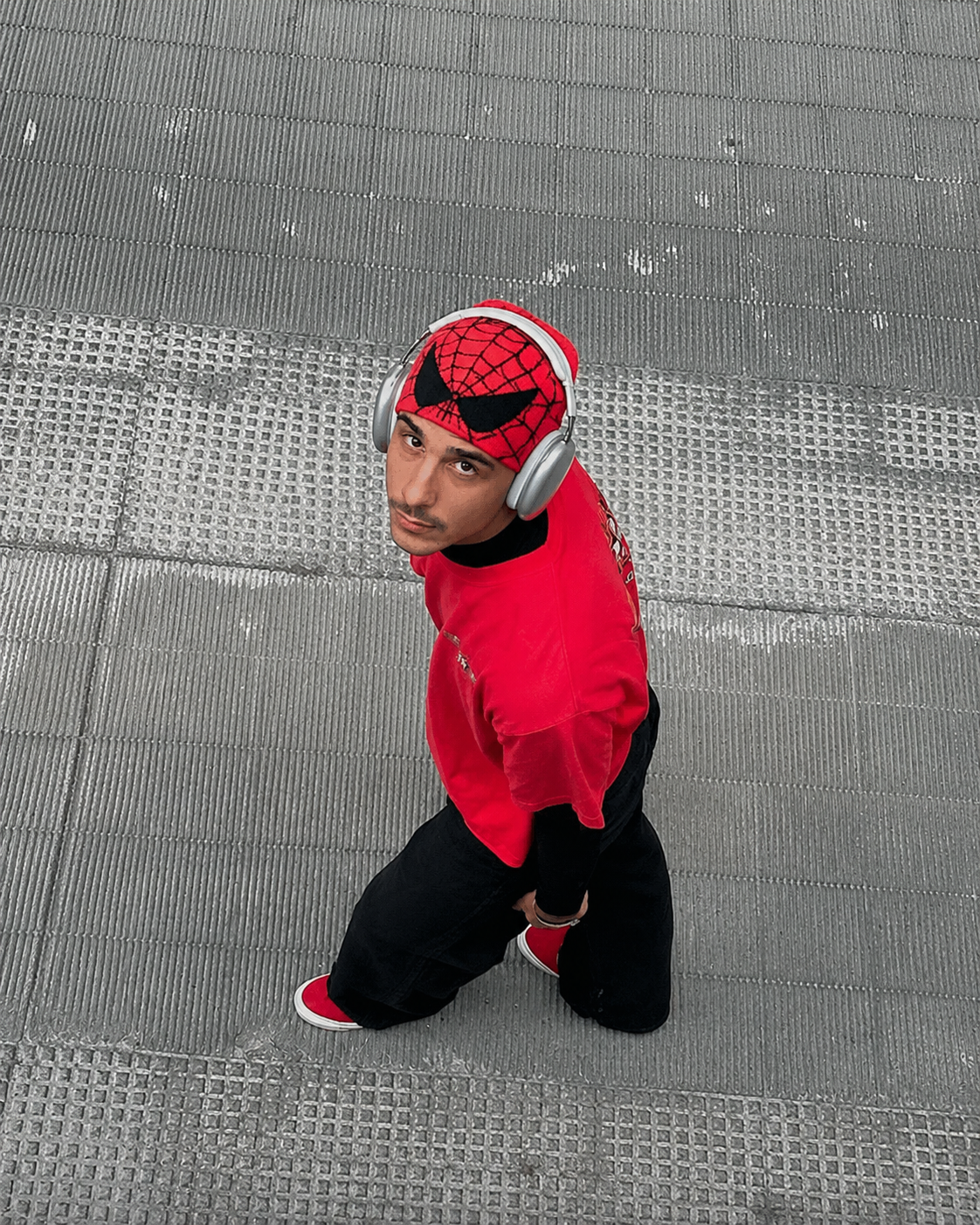 Red and black Spiderman beanie worn streetwear overhead view