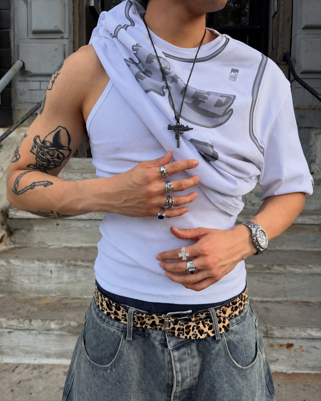 Black UZI necklace worn streetwear with white Y2K outfit