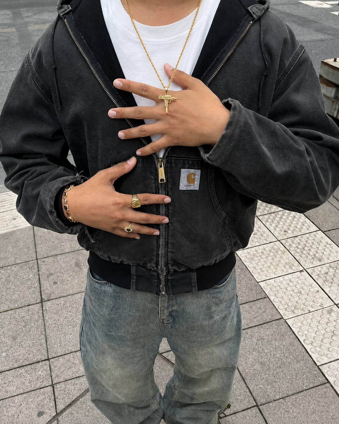 Gold UZI necklace worn streetwear with black hoodie