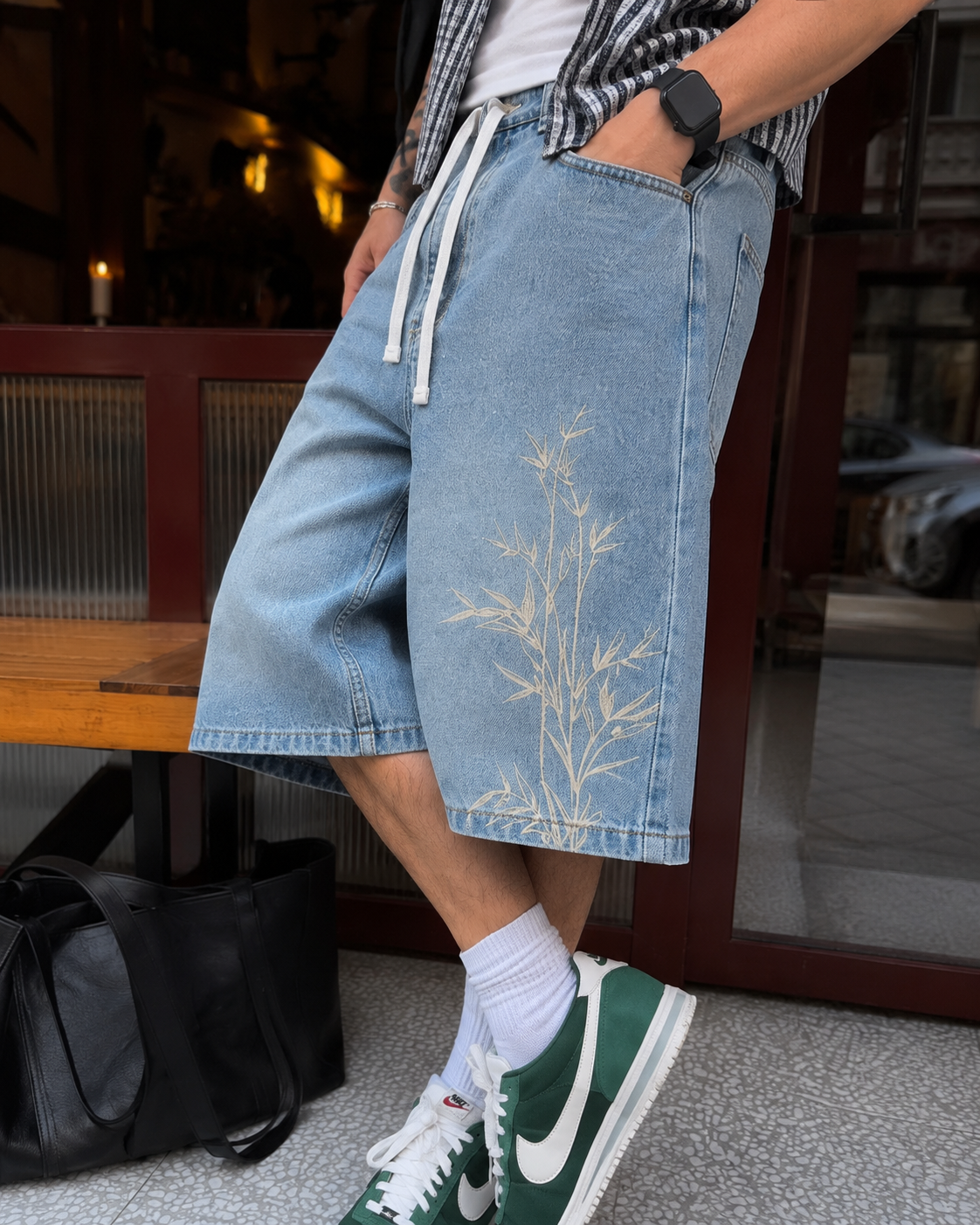 Close-up of bamboo embroidery on light blue jorts