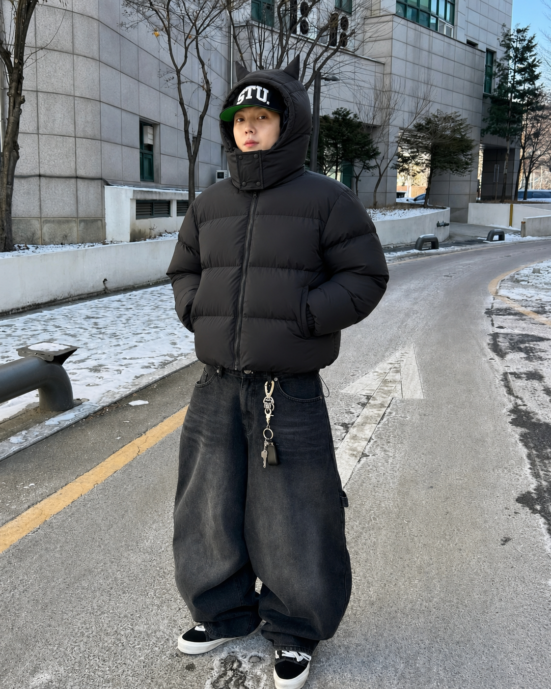Black horn puffer jacket worn with baggy jeans winter Y2K outfit