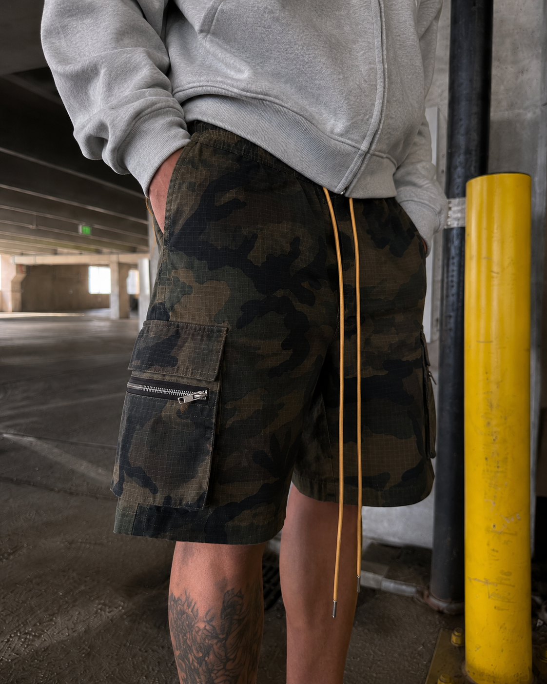 Camo Shorts worn from the front with zipped cargo pocket detail