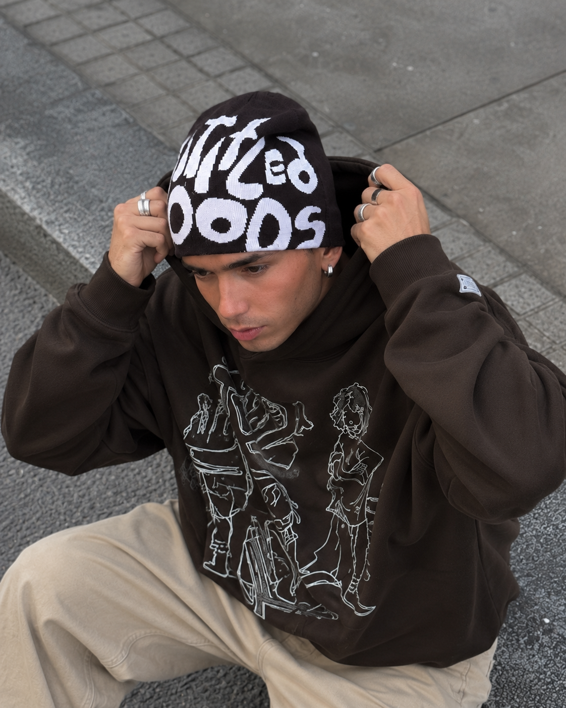 Brown cartoon hoodie worn with hood and beanie