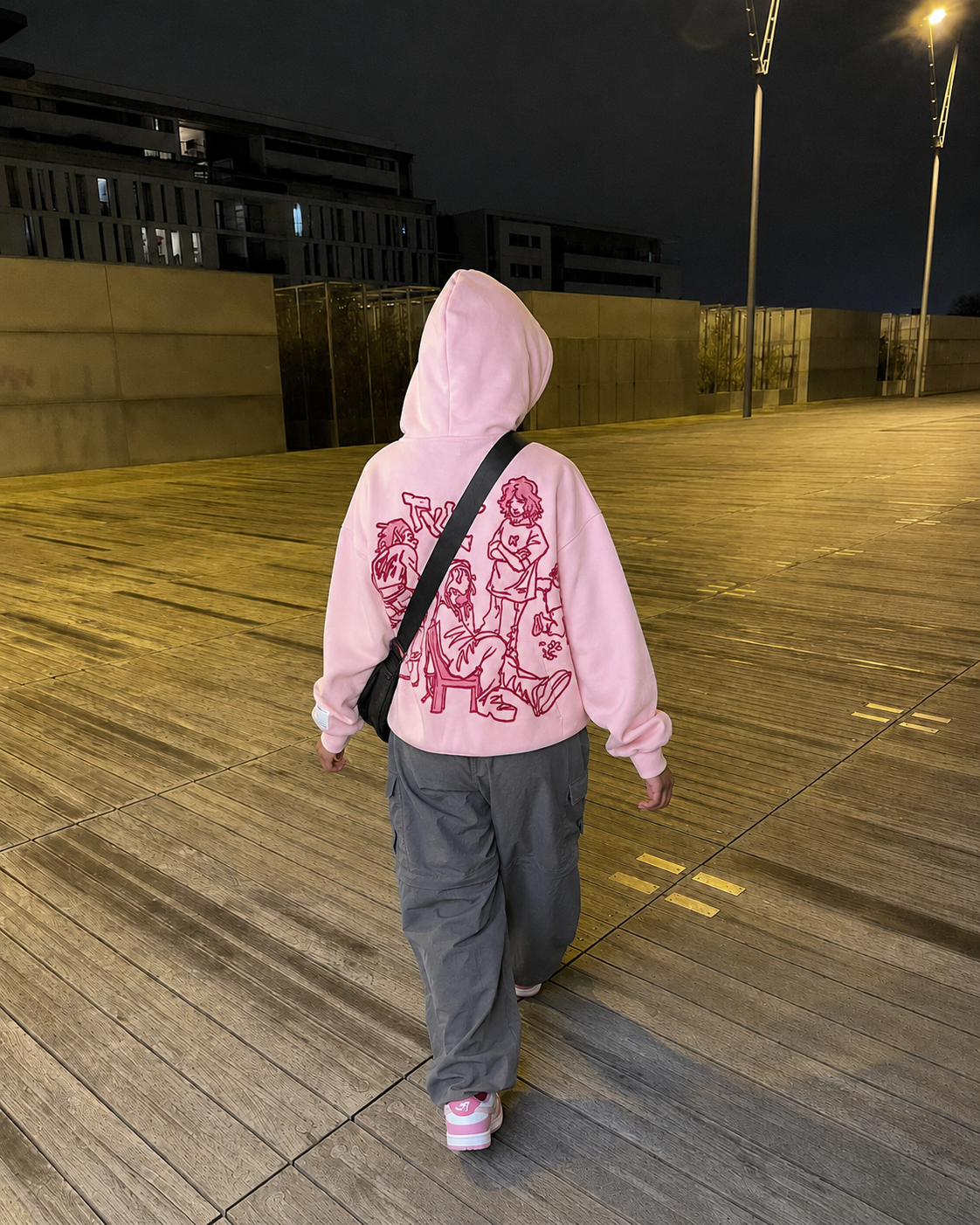 Pink cartoon hoodie worn from the back streetwear
