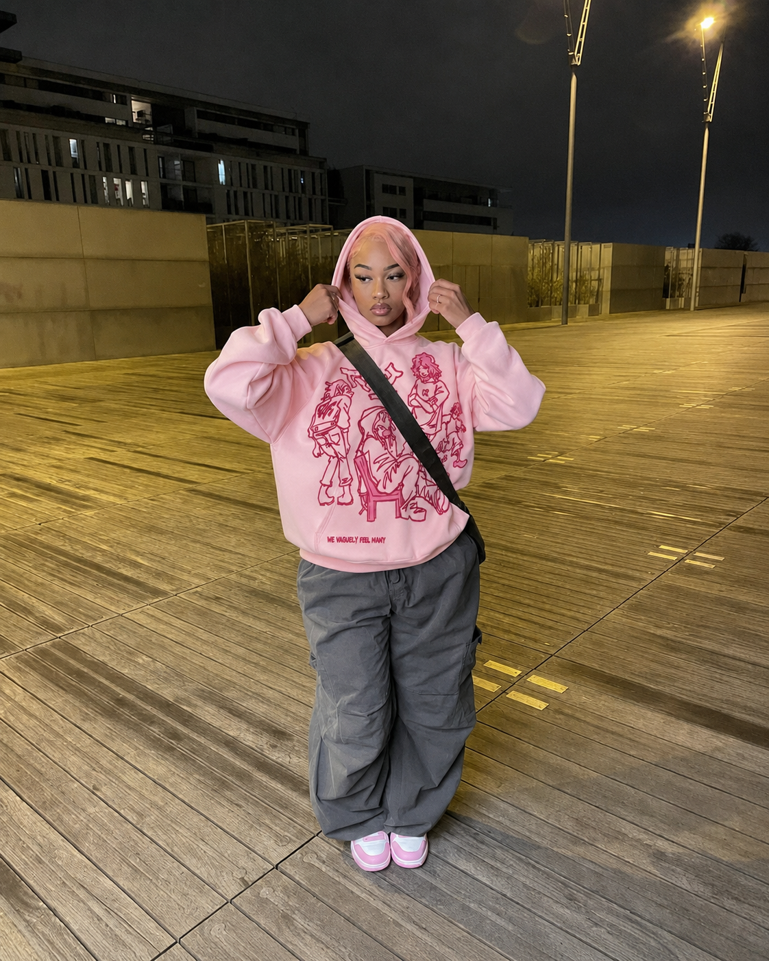 Pink Y2K cartoon hoodie worn streetwear front view