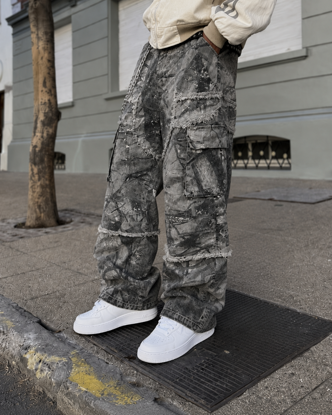 Grey cracked cargo pants lower leg detail with sneakers