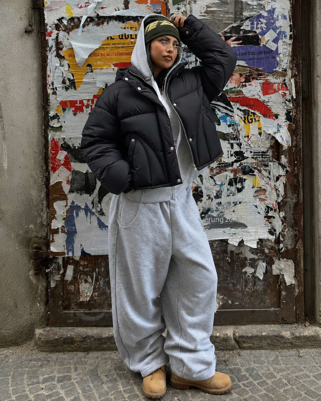 Black cropped puffer jacket worn with grey joggers winter streetwear