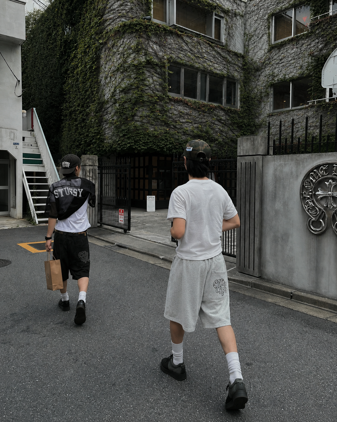 Grey graffiti shorts worn from the back on a Tokyo street