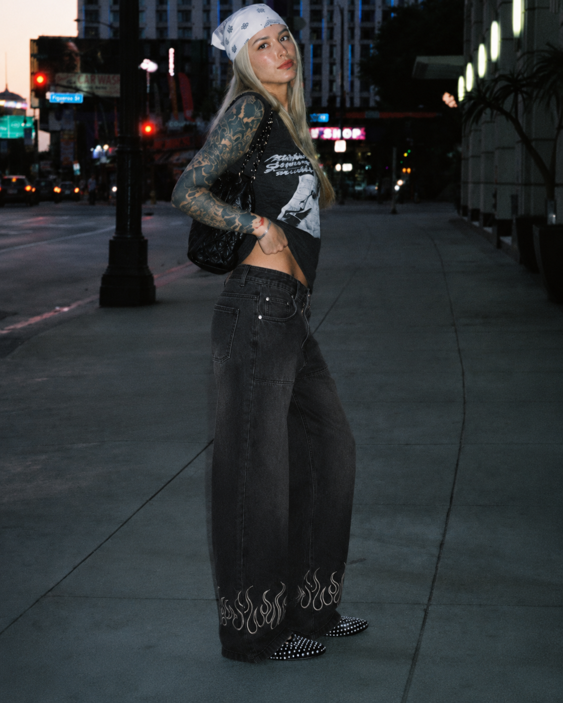 Black flame jeans worn in Y2K streetwear fit