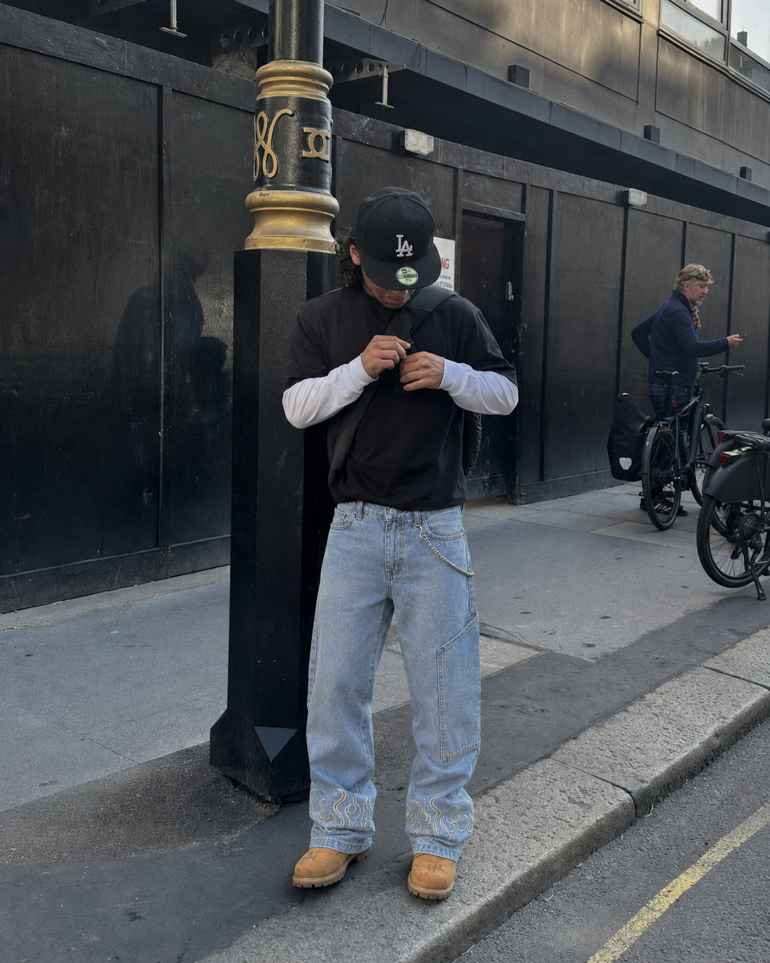 Blue flame jeans worn in Y2K streetwear fit