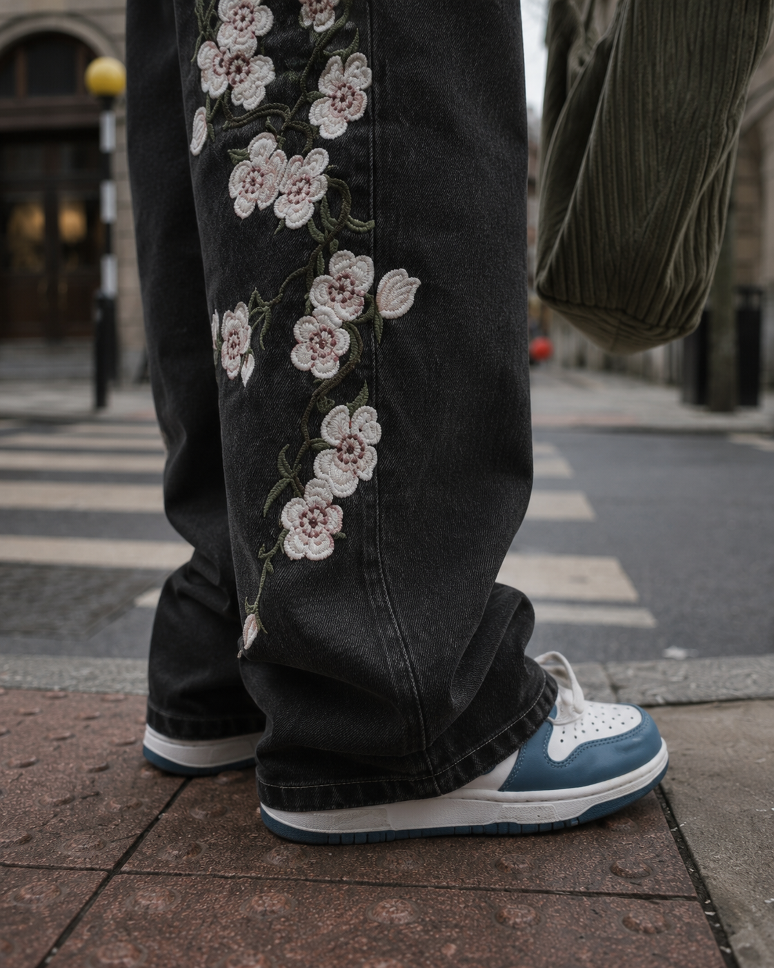 Black flower jeans leg embroidery detail
