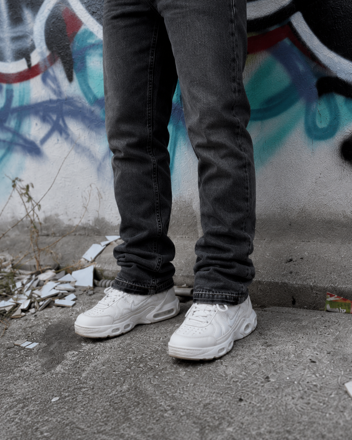 Charcoal flare jeans flared hem over sneakers
