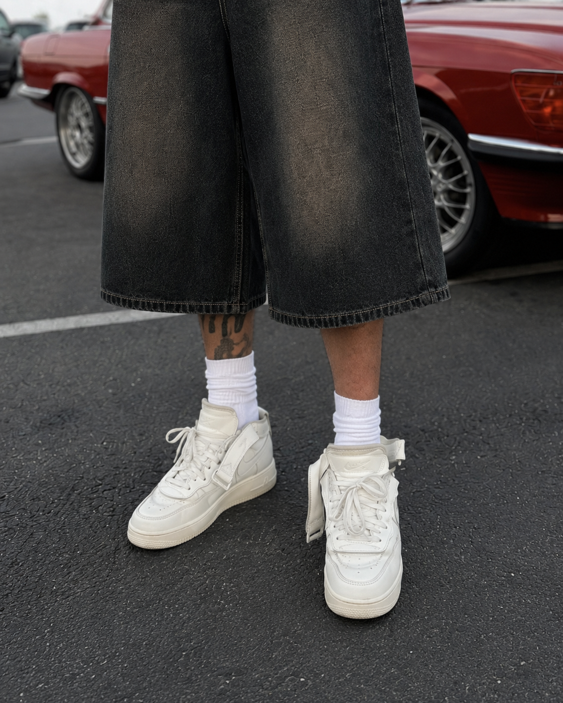 Leg hem detail of baggy black washed denim jorts