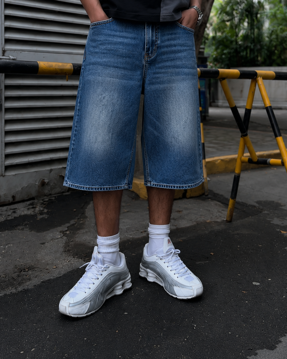 Wide leg cut detail of baggy blue washed denim jorts