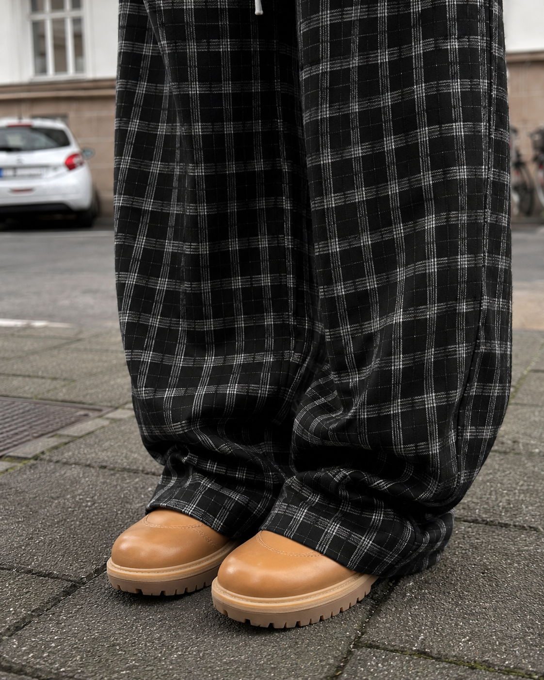 Black plaid pants lower leg detail with sneakers