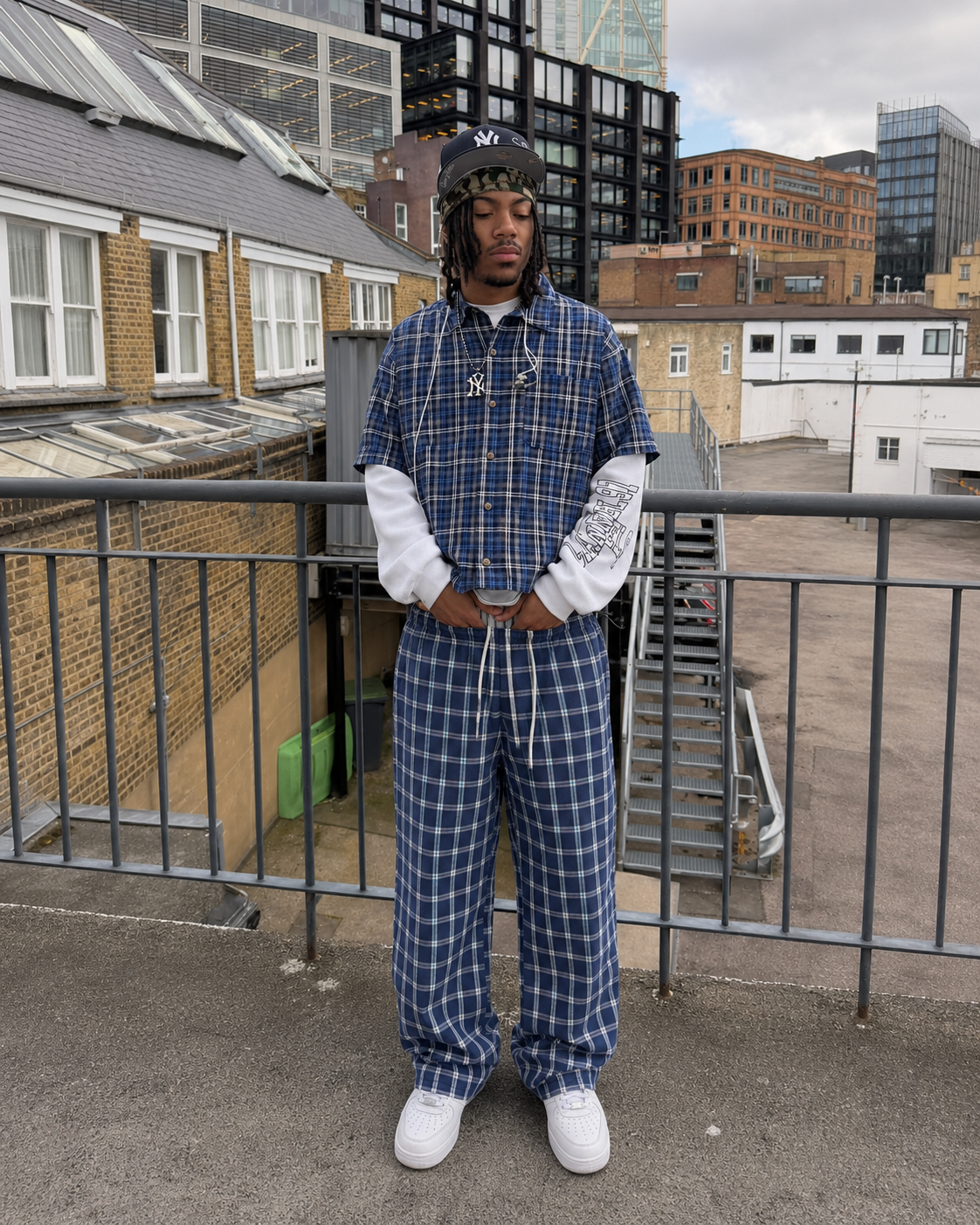 Navy plaid pants worn in Y2K streetwear style