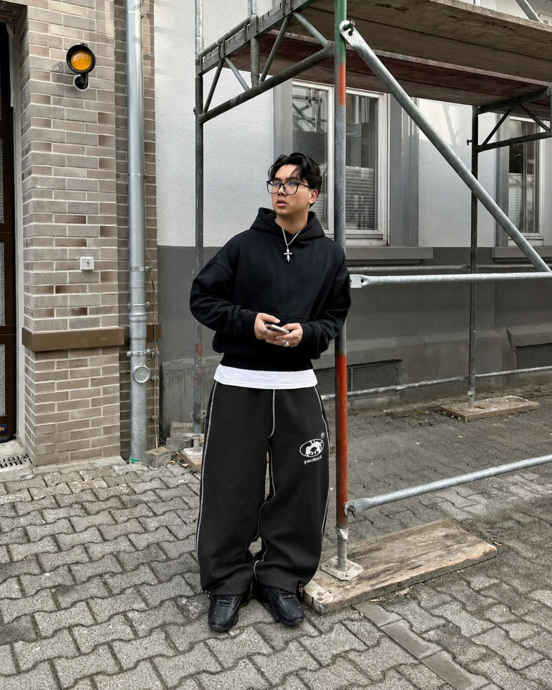 Black Protect sweatpants worn in extra-wide streetwear fit