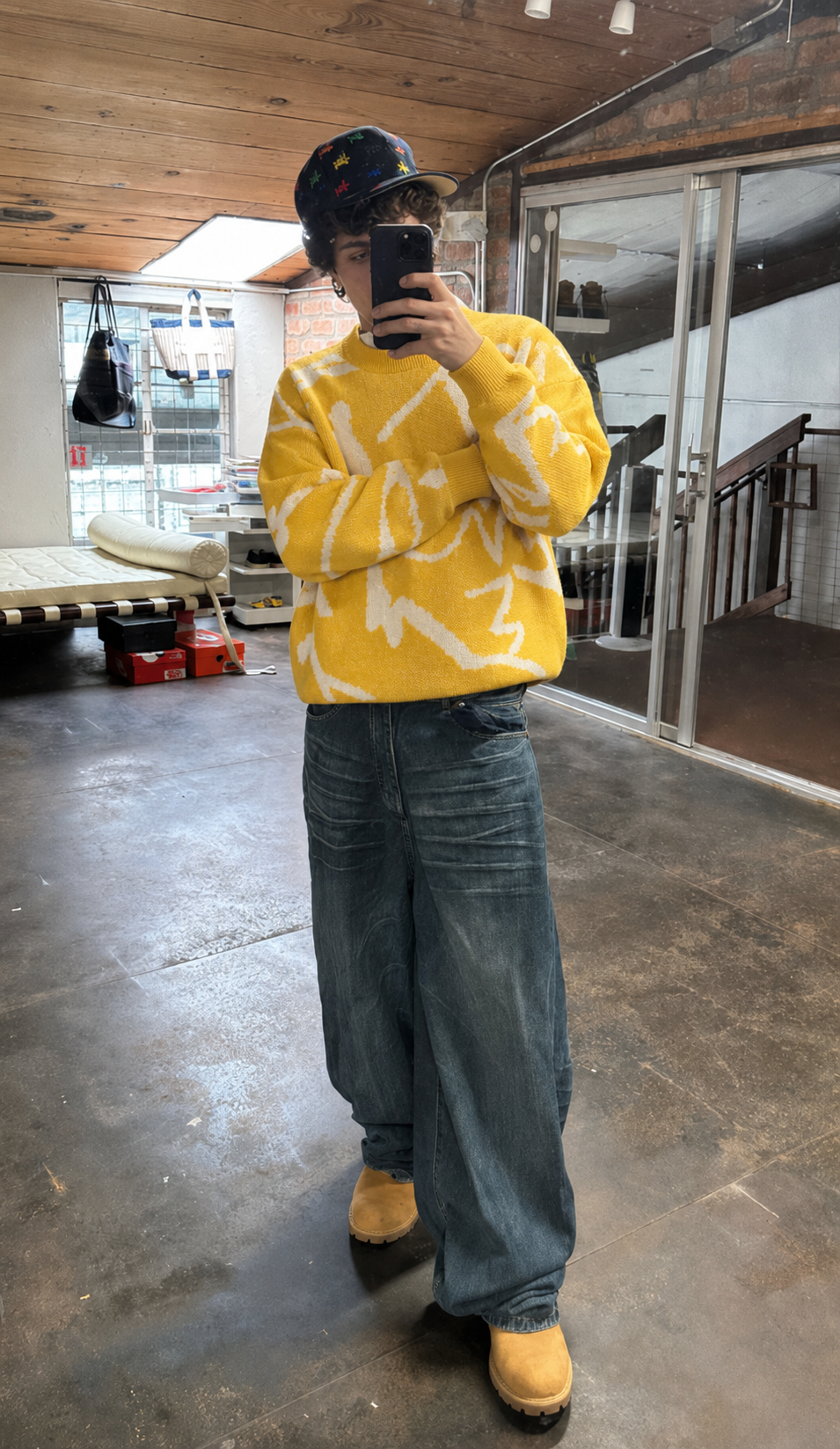 Pull abstrait jaune et blanc porté avec jean baggy