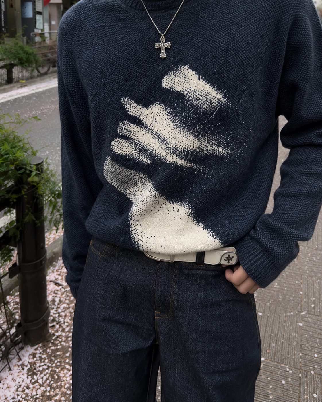 Dark knit sweater close-up of abstract face graphic