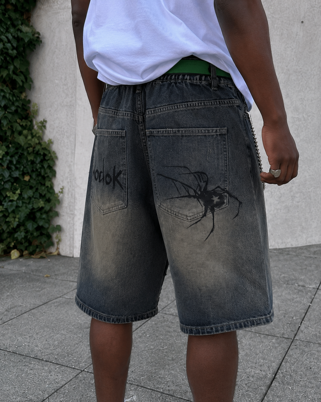 Spider Shorts worn from the back with spider print on the back pockets