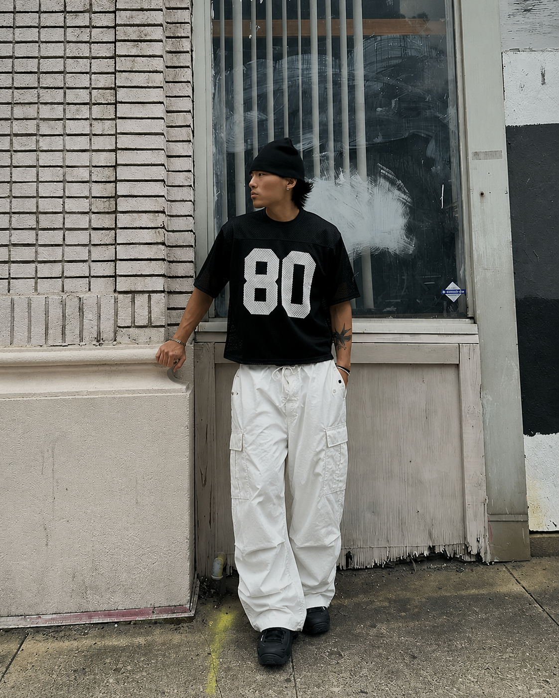 White parachute pants worn in Y2K streetwear look