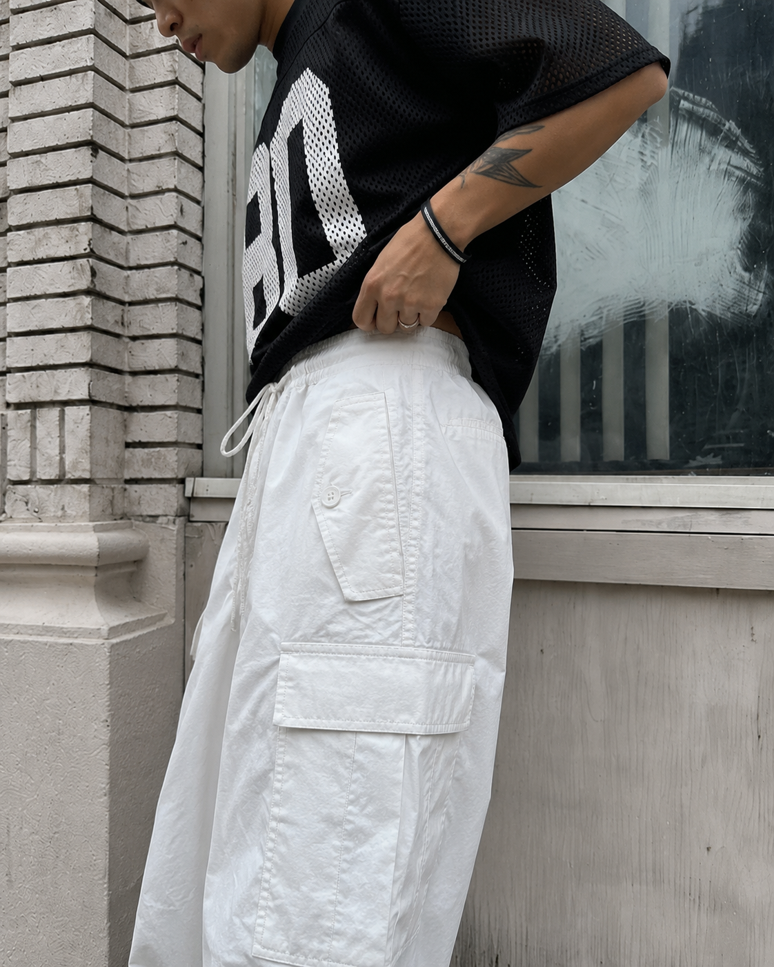 White parachute pants waist drawstring detail