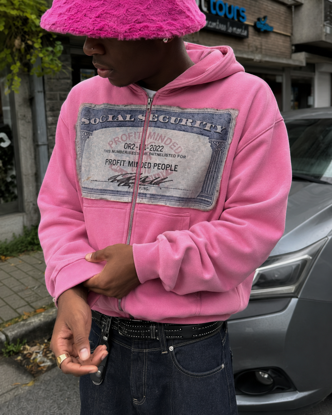 Visual patch detail on pink zip up hoodie
